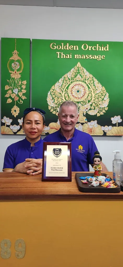 The owners of Golden Orchid Thai Massage with their award